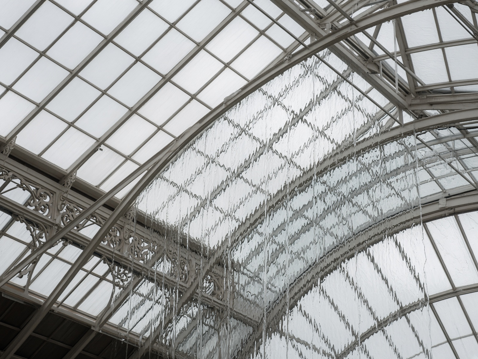 Conservatory glass roof after rain, water sheeting cleanly off the panes